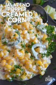 a black plate topped with macaroni and cheese covered in sour cream, garnished with parsley