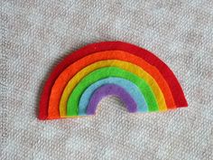 a rainbow made out of felt sitting on top of a table