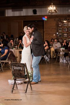 a man and woman standing next to each other on a dance floor