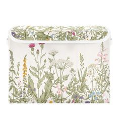 a white storage bag with flowers and plants on it