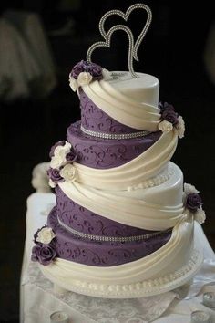 a wedding cake with purple and white decorations