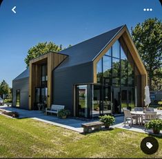 an image of a modern house in the middle of a field with lots of grass