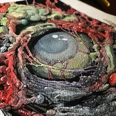 a close up view of an art work with colored inks and watercolor pencils