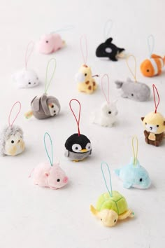 small animal ornaments are arranged on a white surface