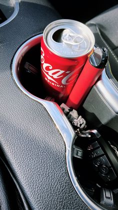 a soda can in the center console of a car