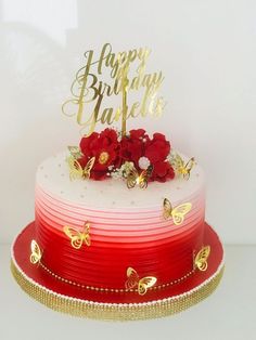 a red and white cake with gold lettering on top