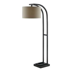 a floor lamp with a beige shade on the base and a black metal frame around it