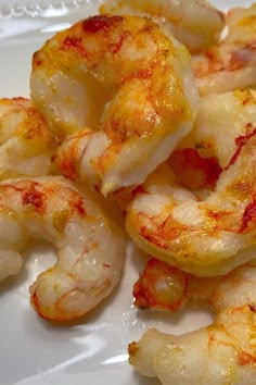 cooked shrimp on a white plate with red sauce