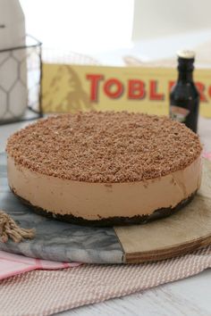 a cake sitting on top of a table next to a bottle of boojut