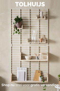 a shelf with plants and books on it in front of a wall that says touhus