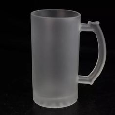 a clear glass mug on a black background