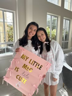 two girls holding up a sign that says, my little is me and her cute