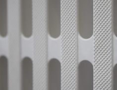 a close up view of the side of a wall with white plastic coverings on it