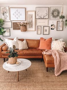 a living room filled with furniture and lots of pictures on the wall above it's coffee table