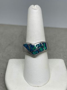 This is a beautiful inlaid Australian opal sterling silver ring that is size 8. This ring features Australian opals that are inlaid into a sterling silver ring. The Opals on this ring originate in Australia and has an amazing fire that ignites in the sunlight. Opals are known for purifying blood, building immunity to help fight off fevers and infections, as well as boosting memory power. Opal is the birthstone associated with the month of October. This ring is handmade and one of a kind. Silver Opal Ring With Inlay, Silver Opal Ring With Inlay For Anniversary, Anniversary Silver Opal Ring With Inlay, Unique Sterling Silver Opal Inlay Ring, Unique Sterling Silver Opal Ring With Inlay, Silver Opal Ring With Polished Finish, Silver Opal Ring With Inlay For Gift, Opal Inlay Ring Gift, Opal Ring With Inlay Perfect For Gifts