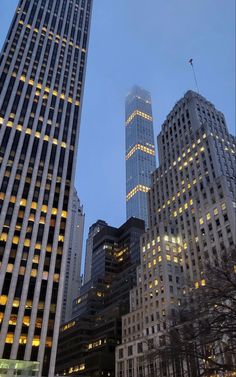 skyscrapers lit up at night in the city