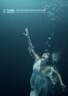 a woman floating in the water with her arms outstretched