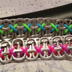 three different colored bracelets sitting on top of each other