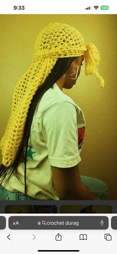 a woman with long hair wearing a yellow crochet hat