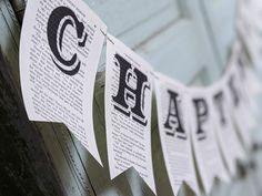 some newspaper paper hanging from a clothesline with the letters c and q on it