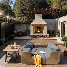 an outdoor fireplace and seating area in a backyard with wood flooring, patio furniture and lighting