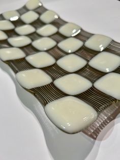 a close up of a plate with white and brown squares on it's surface