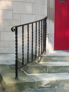 a red door and some steps in front of a building