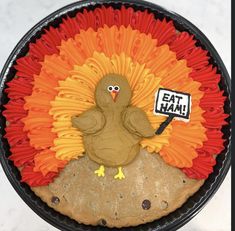 a turkey made out of paper plates with a sign that says eat ham on it