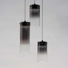 three glass pendants hanging from a ceiling