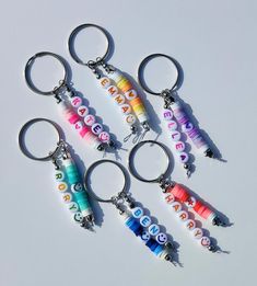 four different key chains with letters on them