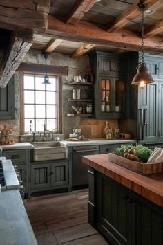 a rustic kitchen with green cabinets and wood flooring, an island countertop and wooden beams