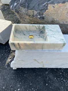 a marble sink sitting on top of a stone slab