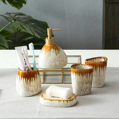 bathroom accessories including soap, toothbrushes and other items on a table