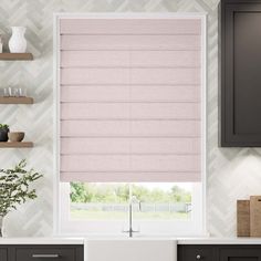 a pink roman blind in a kitchen window