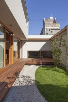 an outdoor area with wooden decking and grass