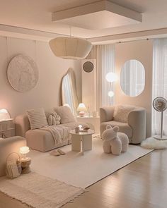 a living room filled with white furniture and lots of round mirrors on the wall above it