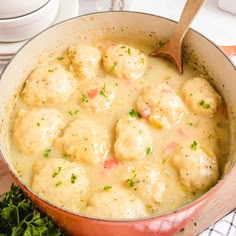 a pot filled with meatballs and gravy on top of a table