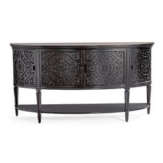 an ornately carved sideboard with two doors and drawers on one end, in dark wood