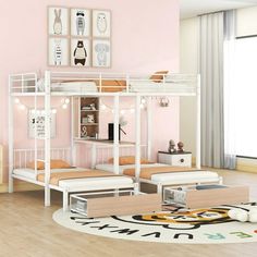 a white bunk bed sitting on top of a wooden floor