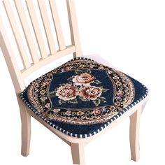 a wooden chair with a blue and white rug on it's seat cushion in front of a white background