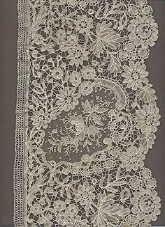 an old lace border with flowers and leaves on the edge is shown in white color