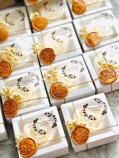 many small white boxes with gold and brown decorations