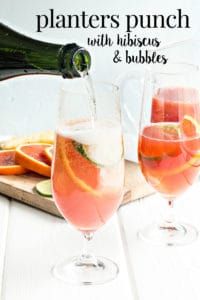 a pitcher and two glasses filled with watermelon, lemon and limeade on a table