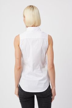 Our warm weather cotton staple. The Sleeveless Shirt is a classic for layering or to wear on its own. Narrow armholes mean bra won't peek through the side (and won't peek through the front either). Rochelle Behrens reimagined how shirts should fit and feel. Our patented No Gape® button technology, seamlessly designed into every shirt and shirtdress we design, eliminates blouse gape. Finally say bye bye blouse gape, hello The Shirt. 75% Cotton, 20% Nylon, 5% Stretch Made In Portugal Powered by ou Back Template, Sleeveless Button Up Shirt, Say Bye, Summer Favorites, White Sleeveless, Women Artisans, The Shirt, Shirtdress, Sleeveless Shirt