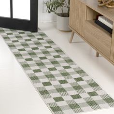 a green and white checkered rug on the floor