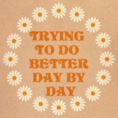 the words trying to do better day by day are arranged in a circle with daisies