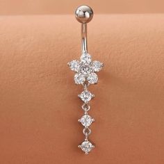 an image of a belly ring with flowers on it