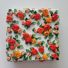 a white box with red, orange and yellow flowers on it