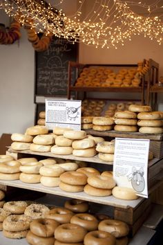 there are many doughnuts on the shelves in this bakery