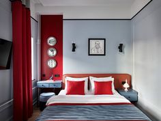 a bed with red and blue sheets in a bedroom